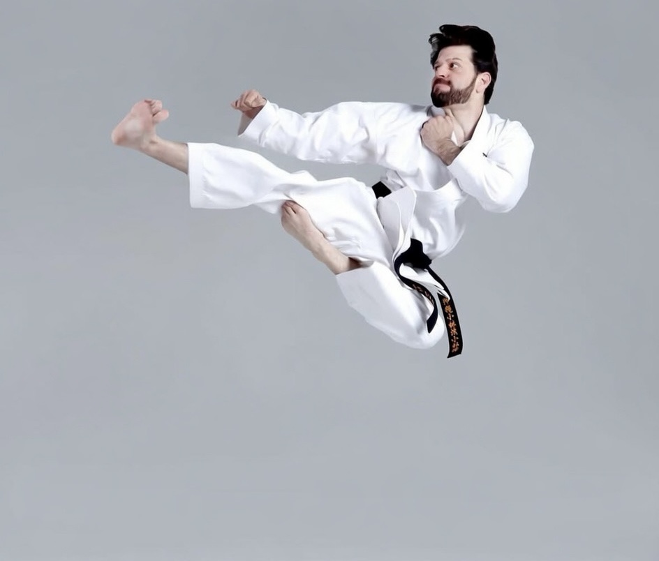 Sari Sabella performing a flying kick in gi